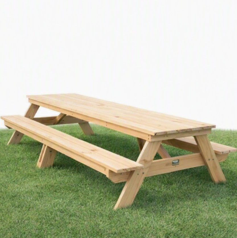 A 3m long A Frame natural pine picnic tables on fake grass.