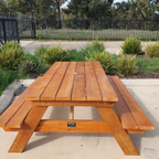 Traditional Pine picnic table in a commercial setting with grass and plants around