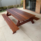 A frame Hardwood picnic table on paved patio.