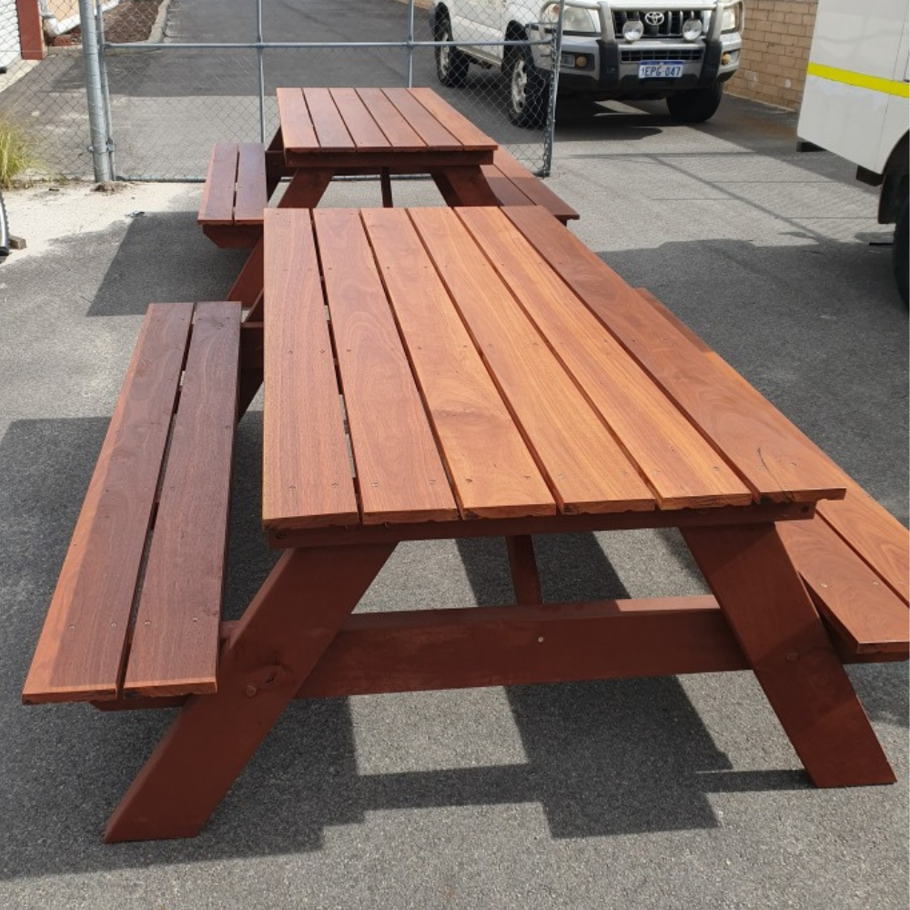 Jarrah A Frame picnic table on a concrete surface with a vehicle in the background