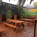 Outdoor seating area with Jarrah A frame picnic tables on a brick patio.