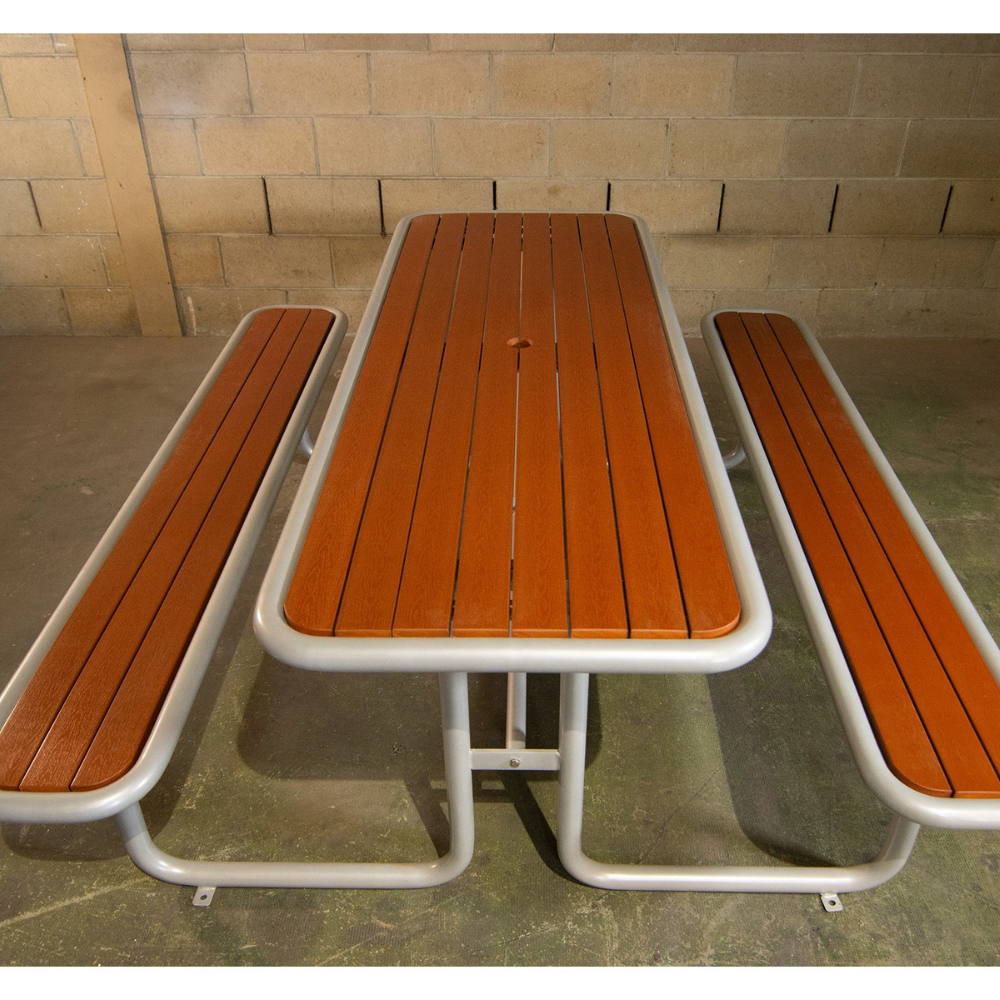 Steel frame picnic table with composite timber surfaces in warehouse