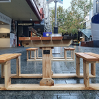 Pine 2 seater picnic table on a city street.